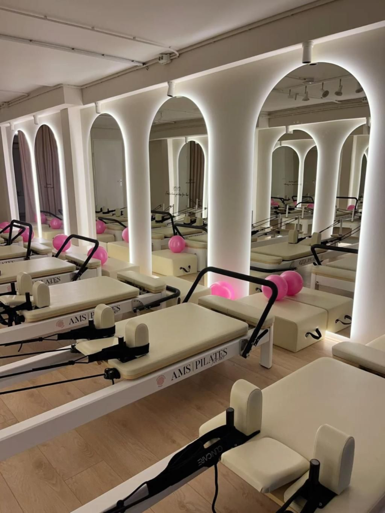 what-is-pilates-reformers-in-a-studio-with-lights-and-mirrors-and-equipment